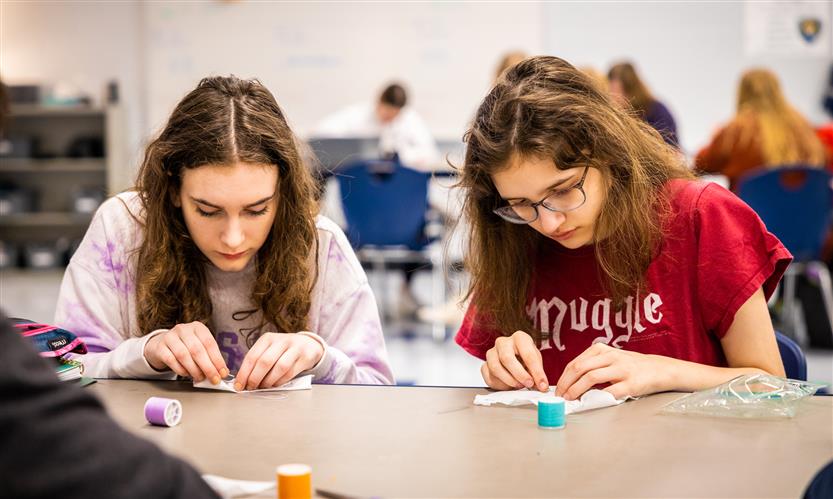 Students practice sewing
